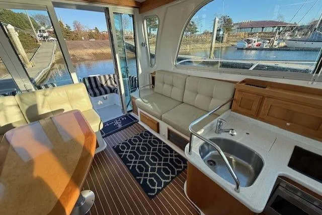 Slide: The Image of Interior of 2015 Back Cove 37 yacht with seating, table, and kitchenette. - 9