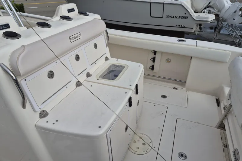 Slide: The Image of 2014 Robalo R300 Center Console boat interior with storage compartments. - 10
