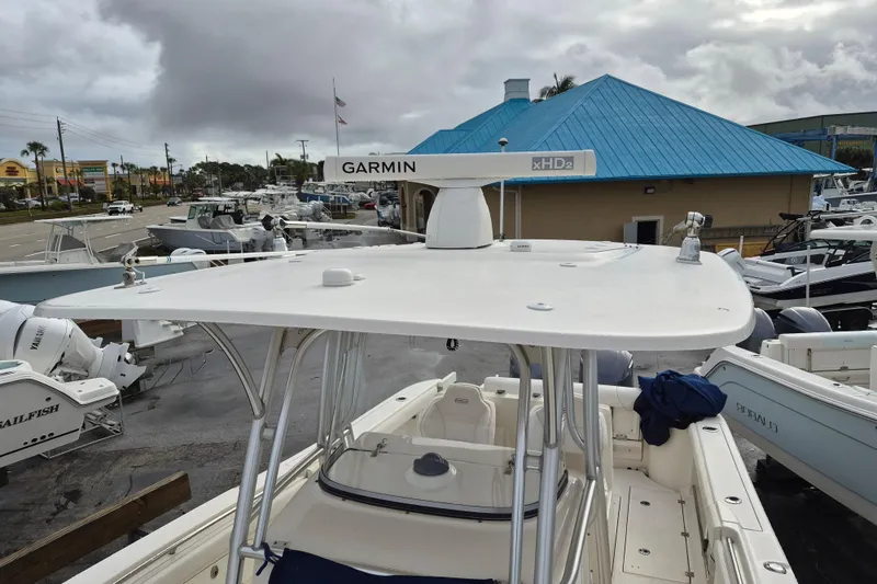 Slide: The Image of 2014 Robalo R300 Center Console boat with Garmin radar, docked at marina. - 13