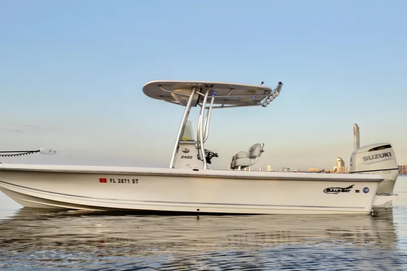 Slide: The Image of 2020 Bulls Bay 2400 boat on calm water with city skyline in background. - 11