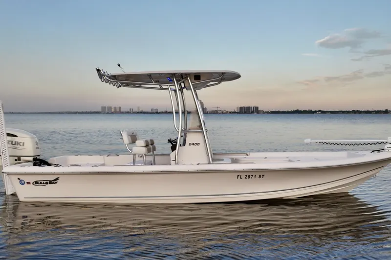 Slide: The Image of 2020 Bulls Bay 2400 boat on calm water with city skyline in background. - 12