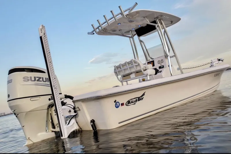 Slide: The Image of 2020 Bulls Bay 2400 boat with Suzuki engine on calm water at sunset. - 15