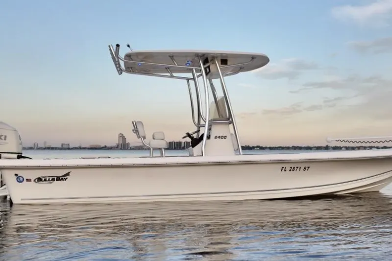 Slide: The Image of 2020 Bulls Bay 2400 boat on calm water at sunset. - 2