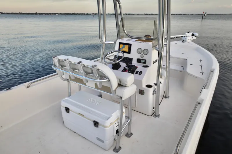 Slide: The Image of 2020 Bulls Bay 2400 boat interior with steering console and seating on calm water. - 24