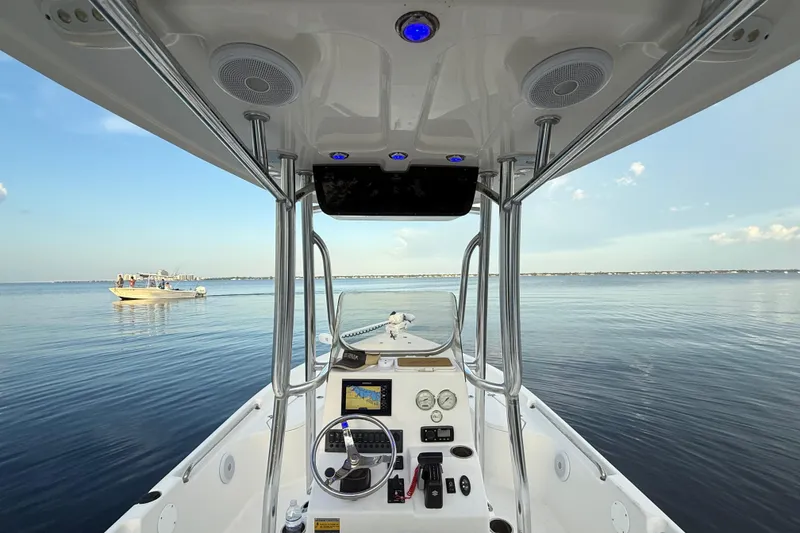 Slide: The Image of 2020 Bulls Bay 2400 boat interior with navigation system on calm water. - 30