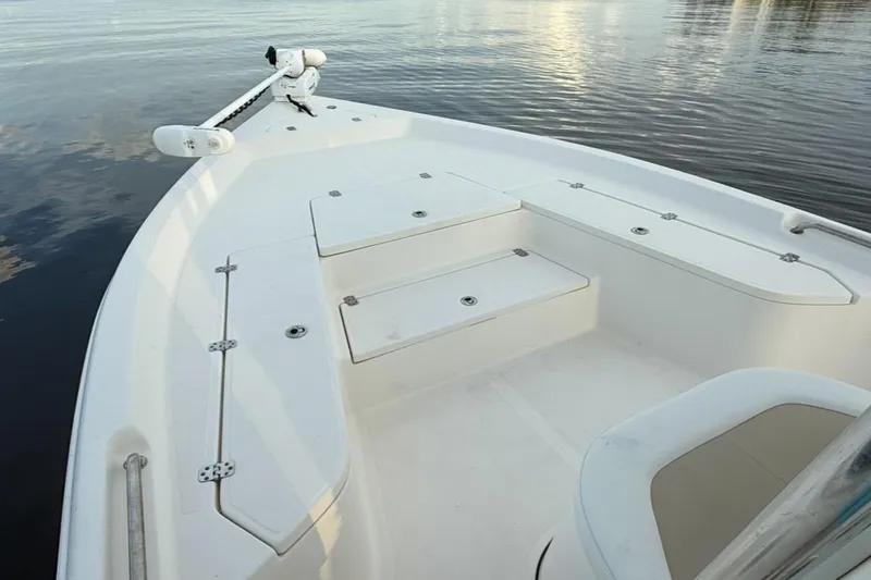 Slide: The Image of 2020 Bulls Bay 2400 boat deck with storage compartments on calm water. - 33