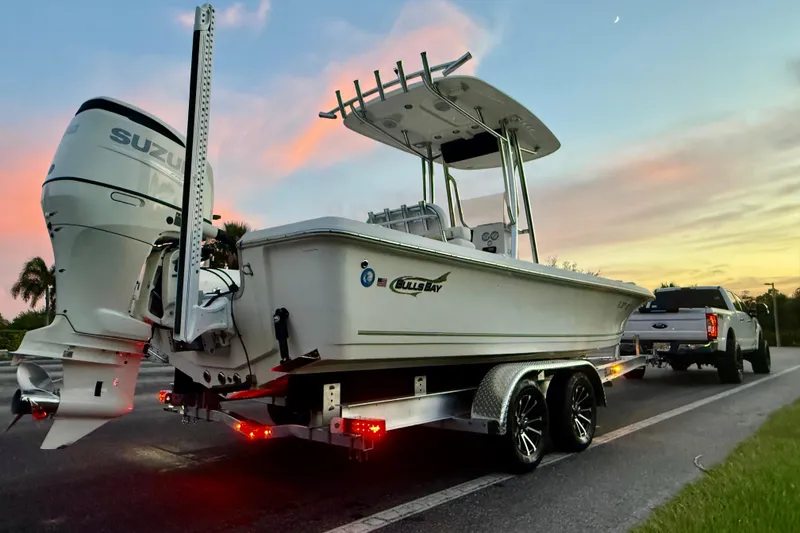 Slide: The Image of 2020 Bulls Bay 2400 boat on trailer at sunset, with Suzuki outboard motor. - 39