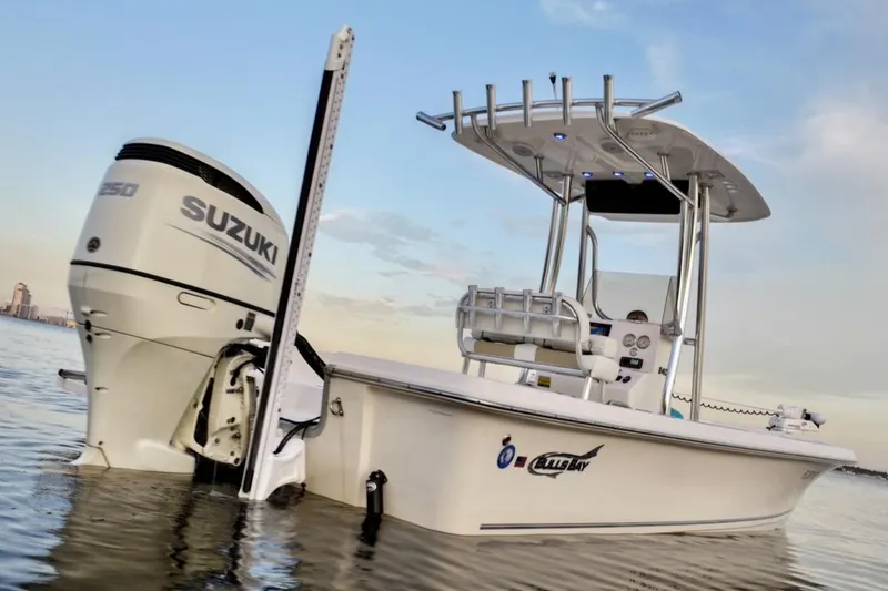 Slide: The Image of 2020 Bulls Bay 2400 boat with Suzuki engine on calm water at sunset. - 4