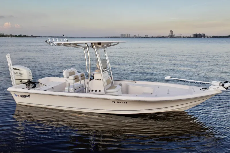 Slide: The Image of 2020 Bulls Bay 2400 boat on calm water with city skyline in background. - 6