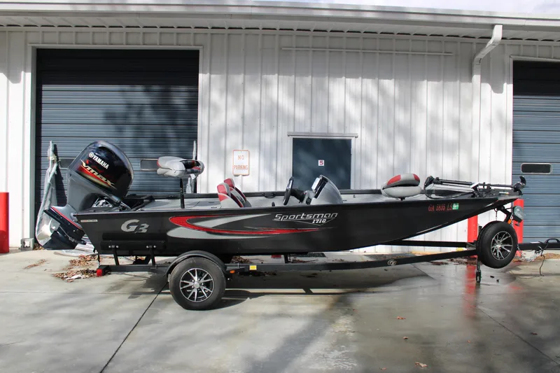 The Image of 2022 G3 Sportsman 1710 boat with Yamaha engine, parked outside a garage. - 1