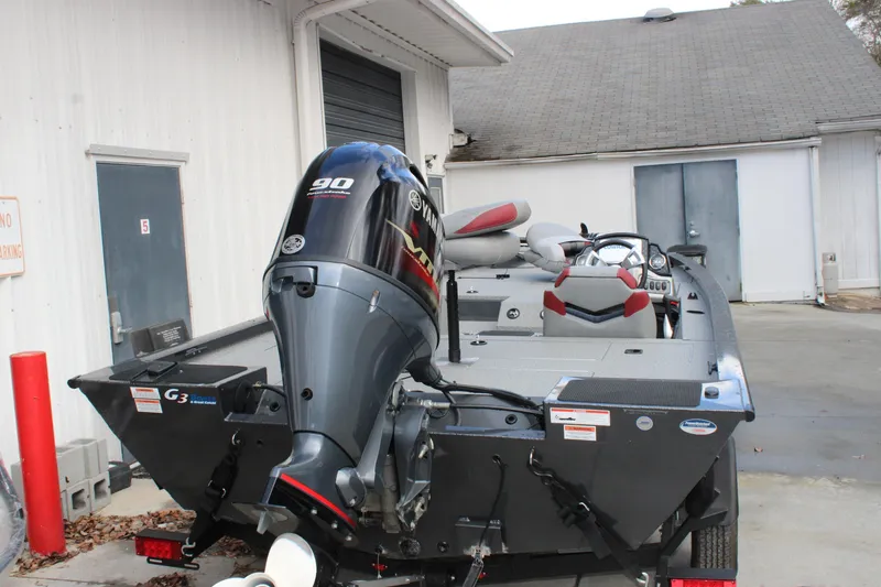 Slide: The Image of 2022 G3 Sportsman 1710 boat with Yamaha 90 engine, parked outside a building. - 12