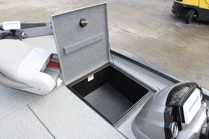 Slide: The Image of 2022 G3 Sportsman 1710 boat with open storage compartment and Lowrance equipment. - 7