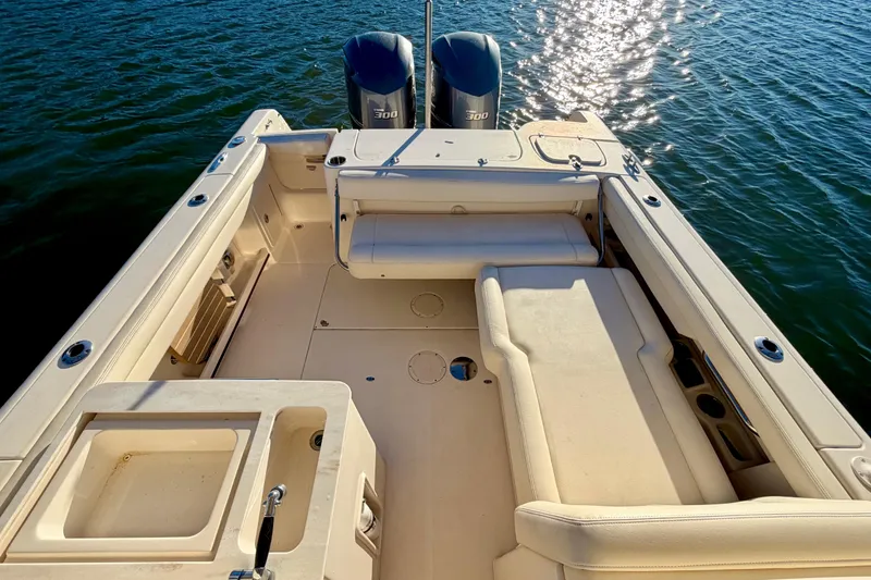 Slide: The Image of 2019 Grady-White Freedom 285 boat interior with dual engines on water. - 11