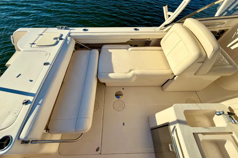 Slide: The Image of 2019 Grady-White Freedom 285 boat interior with cushioned seating and water view. - 12