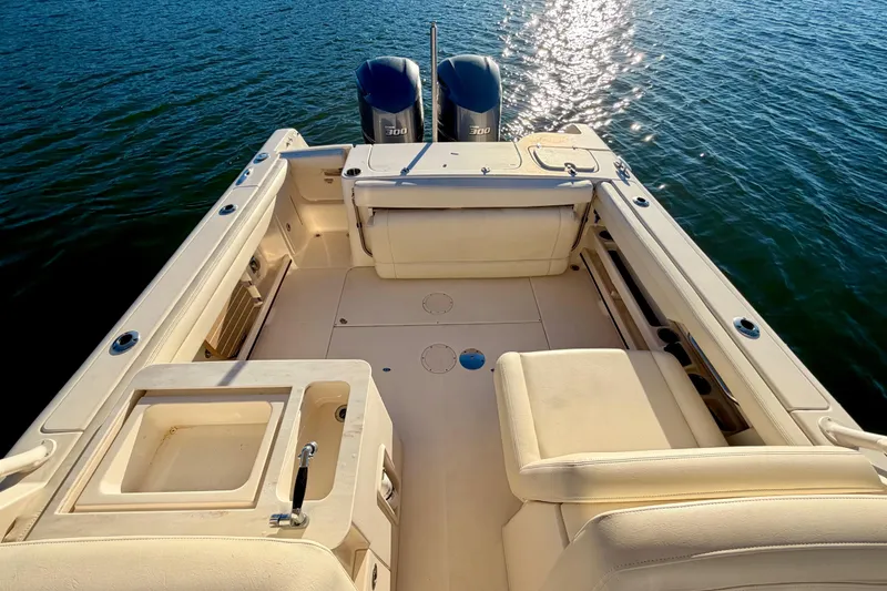 Slide: The Image of 2019 Grady-White Freedom 285 boat interior with dual engines on water. - 13