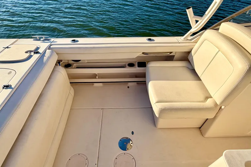 Slide: The Image of 2019 Grady-White Freedom 285 boat interior with beige seating and water view. - 15
