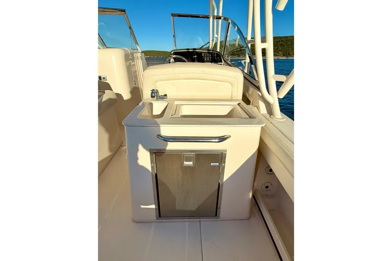 Slide: The Image of 2019 Grady-White Freedom 285 boat interior with sink and storage. - 18