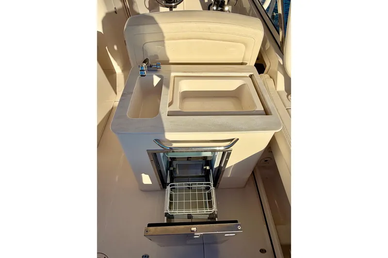 Slide: The Image of 2019 Grady-White Freedom 285 boat interior with sink and storage drawer. - 19