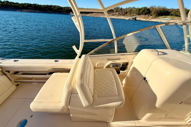 Slide: The Image of 2019 Grady-White Freedom 285 boat interior with seating, on a sunny day by the water. - 21