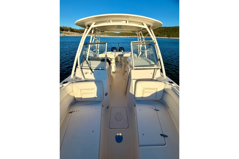 Slide: The Image of 2019 Grady-White Freedom 285 boat interior on calm water, showcasing seating and helm. - 25