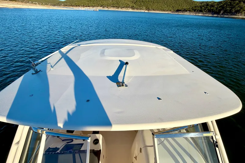Slide: The Image of 2019 Grady-White Freedom 285 boat on calm blue water, viewed from the bow. - 28