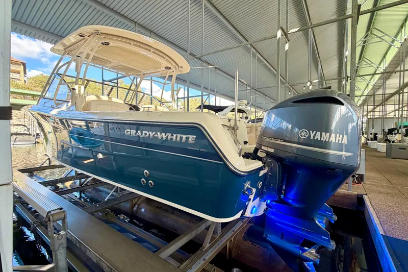 Slide: The Image of 2019 Grady-White Freedom 285 boat with Yamaha engine in a covered dock. - 30