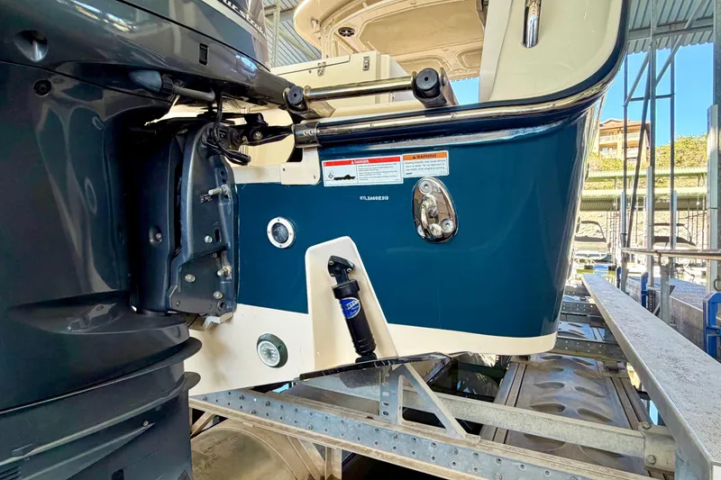 Slide: The Image of 2019 Grady-White Freedom 285 boat on a lift, showcasing the stern and motor details. - 36