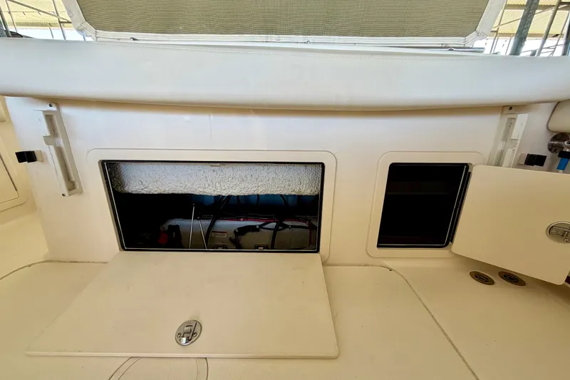 Slide: The Image of 2019 Grady-White Freedom 285 boat storage compartments and seating area. - 42