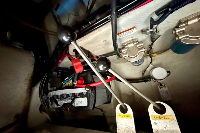 Slide: The Image of 2019 Grady-White Freedom 285 boat interior showing control levers and wiring. - 43