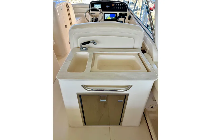 Slide: The Image of 2019 Grady-White Freedom 285 boat interior with sink and storage area. - 45