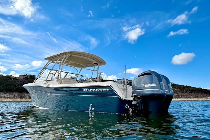 Slide: The Image of 2019 Grady-White Freedom 285 boat on water with Yamaha engine, under blue sky. - 5