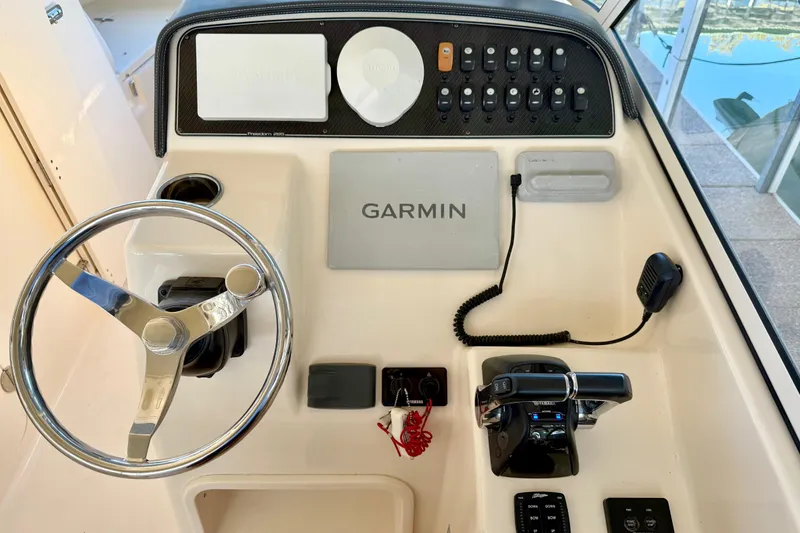 Slide: The Image of 2019 Grady-White Freedom 285 boat dashboard with Garmin navigation system and controls. - 52