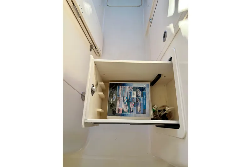 Slide: The Image of 2019 Grady-White Freedom 285 boat storage compartment with manual and accessories. - 57