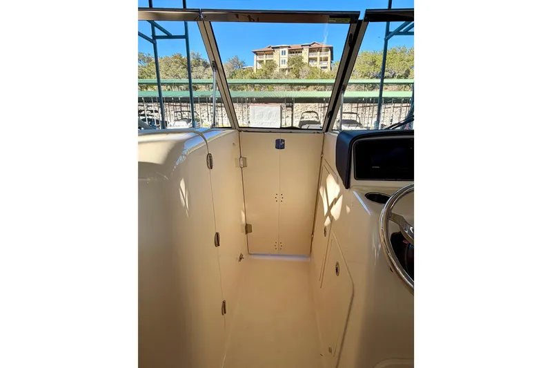 Slide: The Image of 2019 Grady-White Freedom 285 boat interior with helm and cabin door. - 58