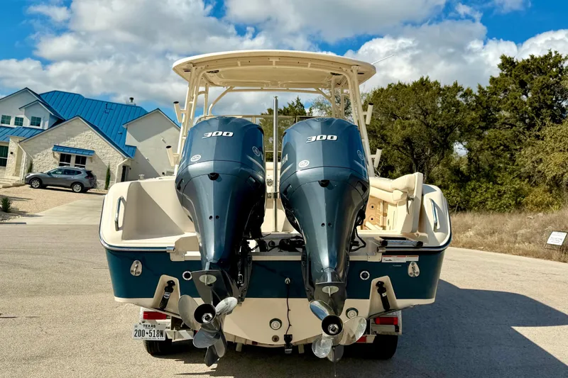 Slide: The Image of 2019 Grady-White Freedom 285 boat with dual 300 horsepower engines, parked outdoors. - 65