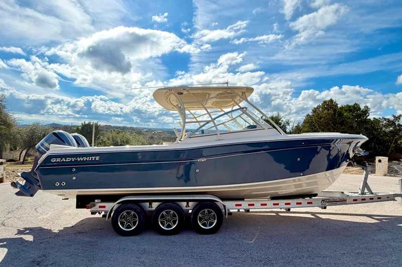 Slide: The Image of 2019 Grady-White Freedom 285 boat on trailer under a blue sky. - 67
