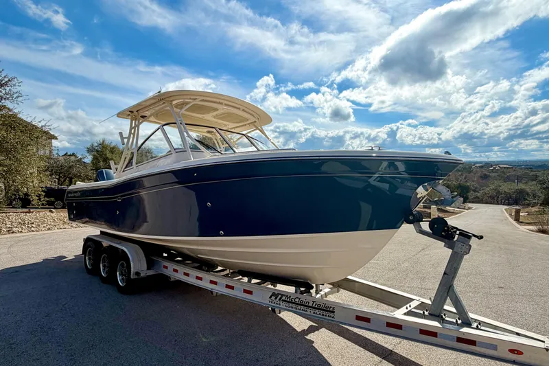 Slide: The Image of 2019 Grady-White Freedom 285 boat on trailer under a bright blue sky. - 68