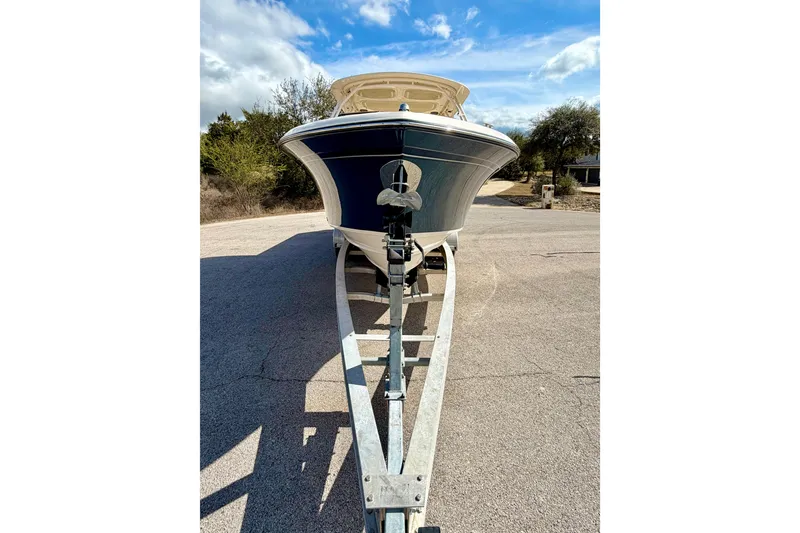 Slide: The Image of 2019 Grady-White Freedom 285 boat on trailer, parked outdoors under blue sky. - 69