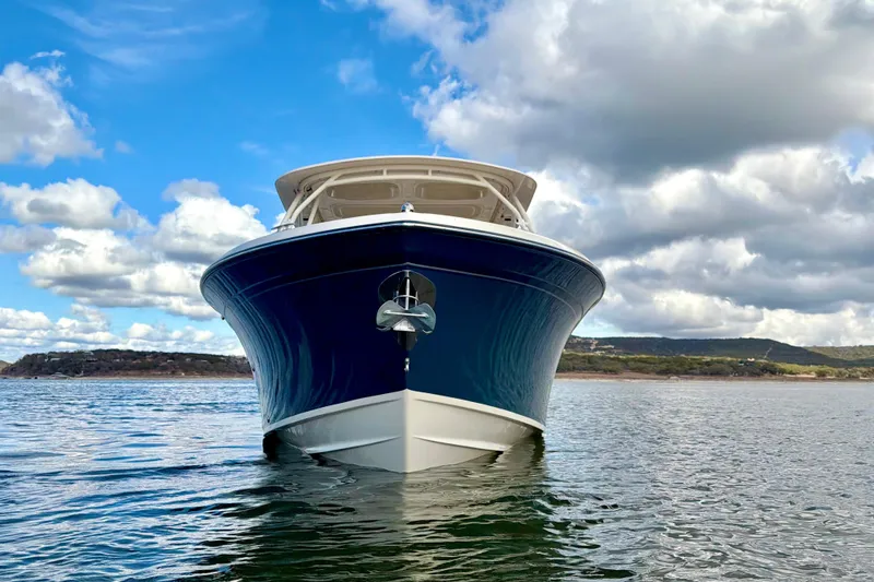 Slide: The Image of 2019 Grady-White Freedom 285 boat on calm water under cloudy sky. - 7