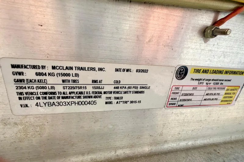 Slide: The Image of Label on McClain trailer showing specifications and tire information, manufactured March 2022. - 70