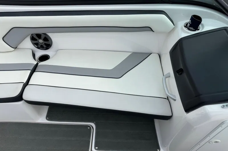 Slide: The Image of 2017 Yamaha AR195 boat interior with white and gray seating, speaker, and cup holder. - 12