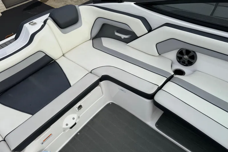 Slide: The Image of 2017 Yamaha Boats AR195 interior seating with sleek design and integrated speaker. - 13