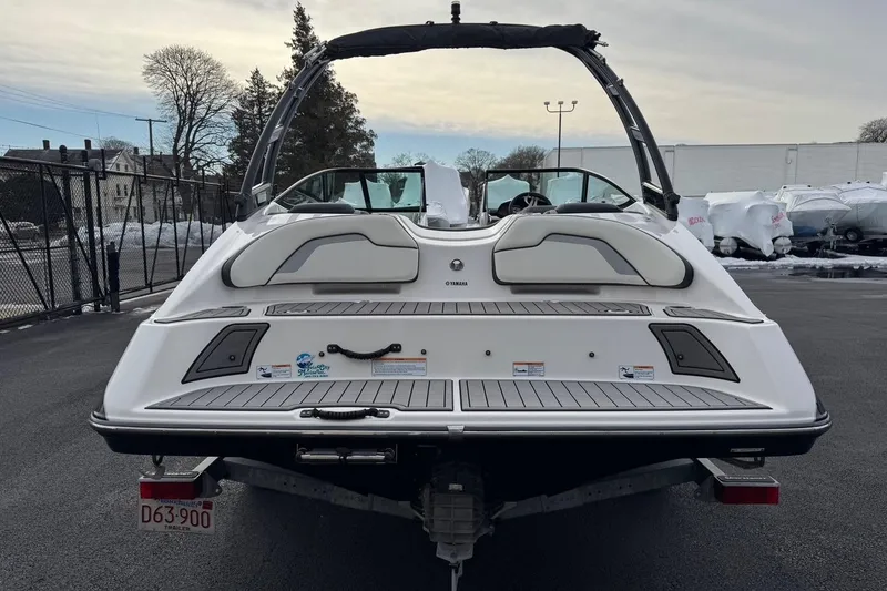 Slide: The Image of 2017 Yamaha Boats AR195, rear view, parked on asphalt with snow in background. - 19
