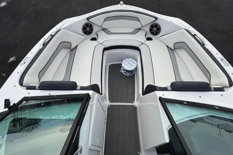 Slide: The Image of 2017 Yamaha Boats AR195 interior with white cushioned seating and speakers. - 2