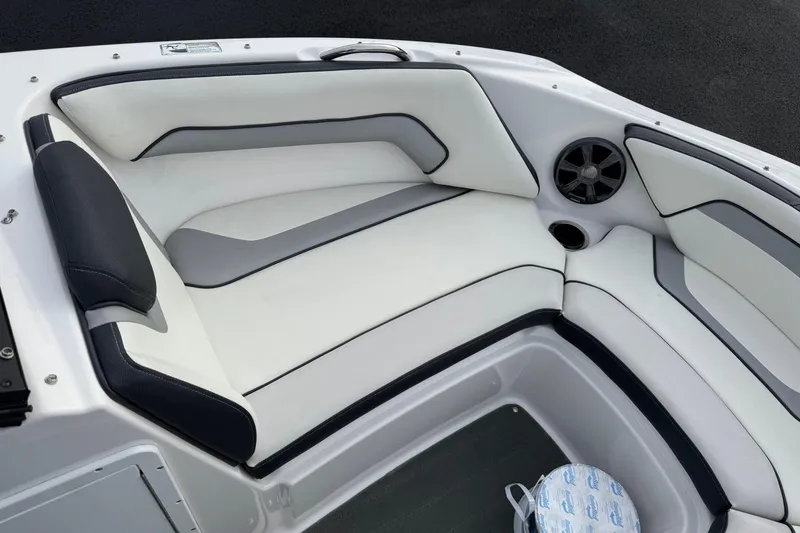 Slide: The Image of 2017 Yamaha Boats AR195 interior seating with sleek white and gray upholstery. - 5
