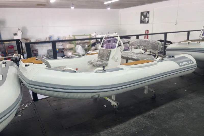 Slide: The Image of 2024 Gala A330L inflatable boat in a workshop, partially assembled and wrapped. - 1