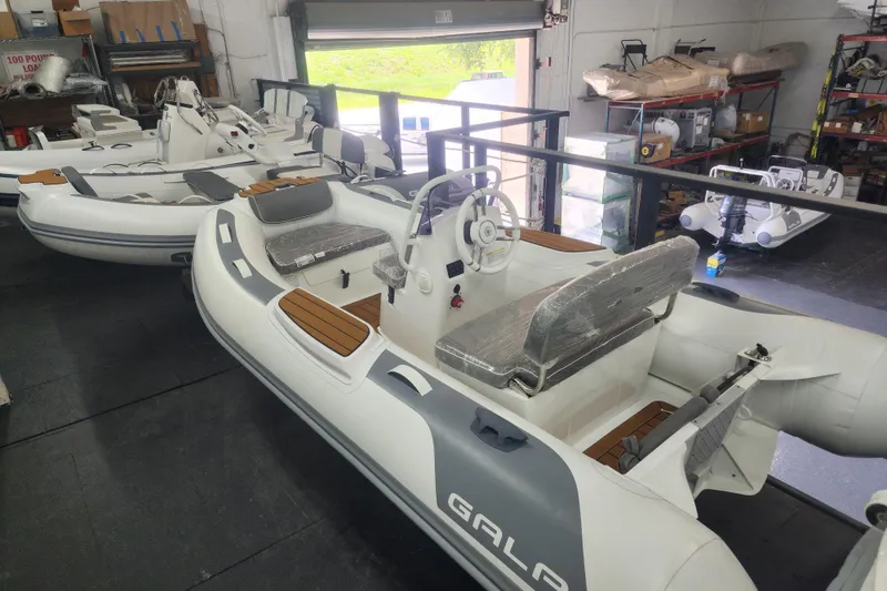 Slide: The Image of 2024 Gala A330L inflatable boats in a showroom, featuring sleek design and modern interiors. - 2