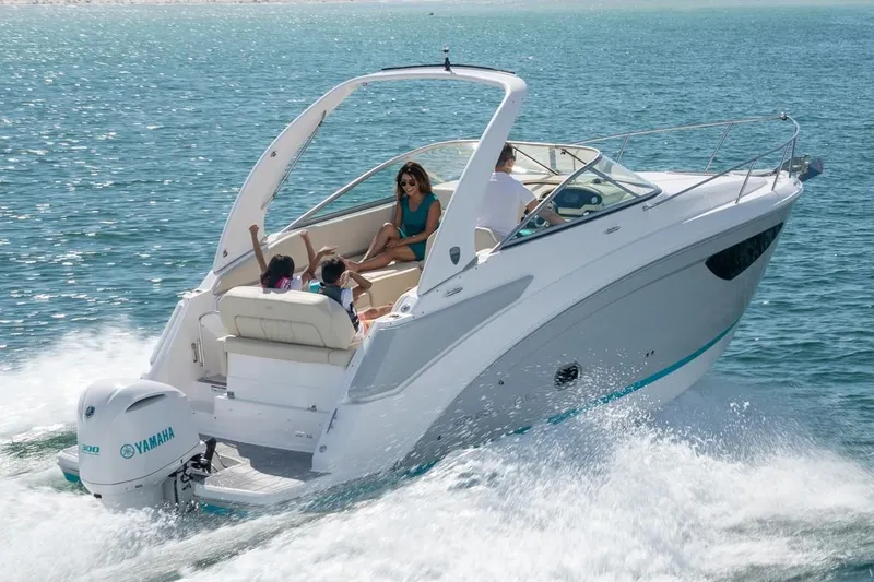 Slide: The Image of 2021 Regal 26 XO boat with outboard motor docked at marina. - 2