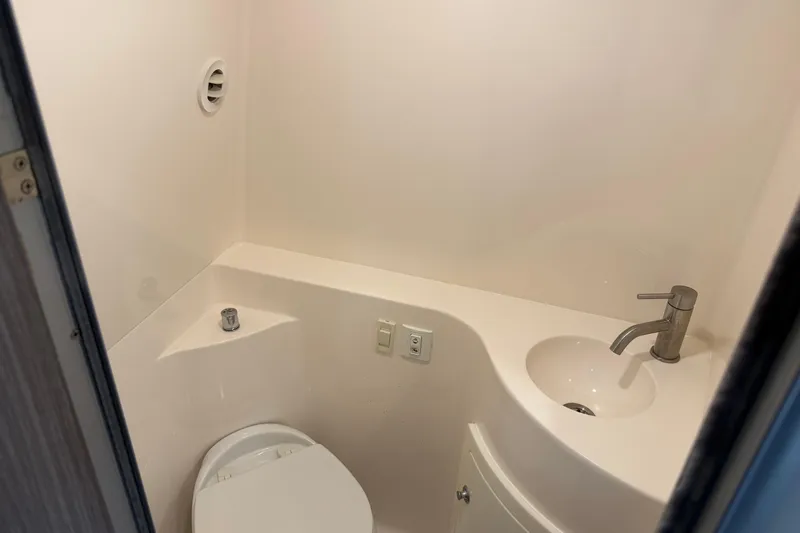 Slide: The Image of Compact bathroom in 2021 Regal 26 XO boat with toilet and sink. - 22