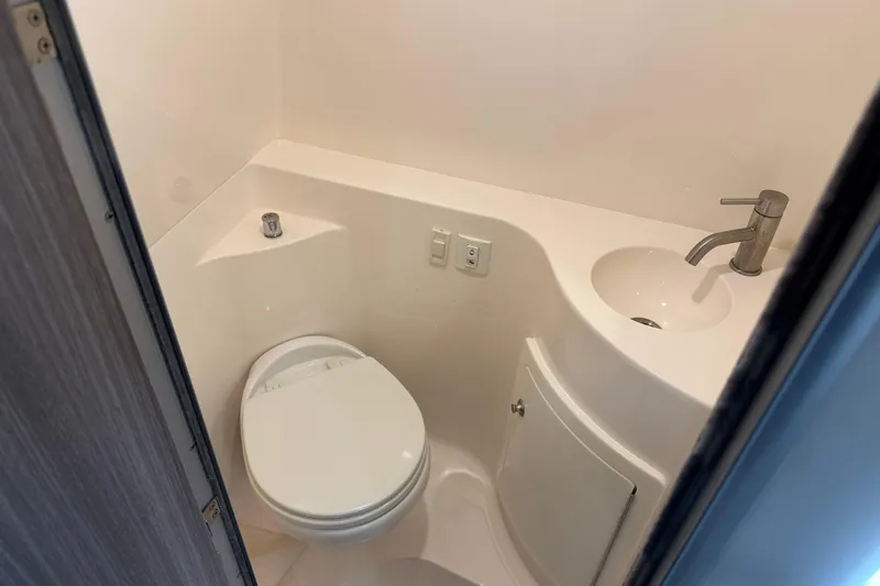 Slide: The Image of Compact bathroom in 2021 Regal 26 XO boat with toilet and sink. - 23